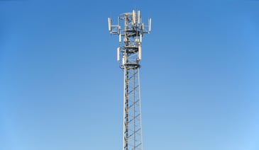 Tall telecommunications tower and clear blue sky